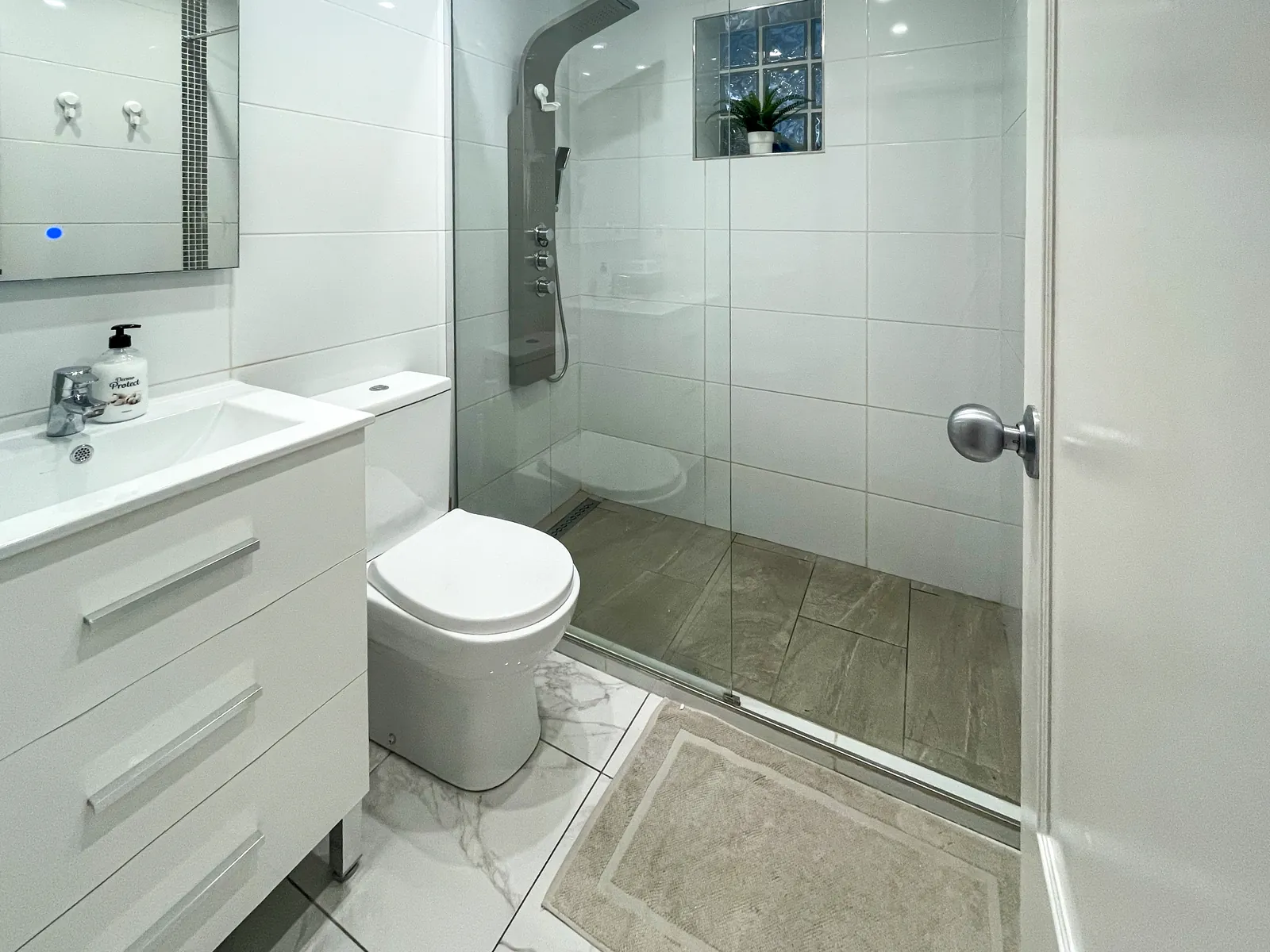 Bathroom with a walk-in shower, a vanity unit and a toilet