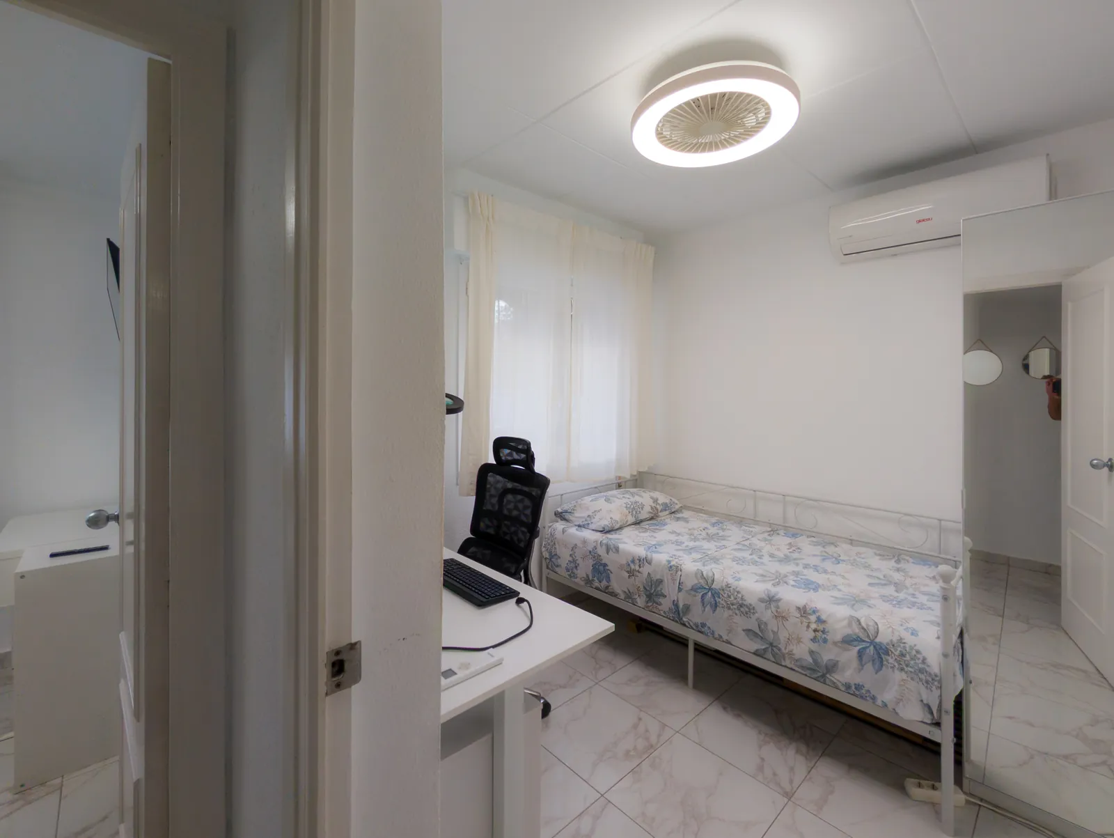 Single bed, a desk with an ergonomic chair and a ceiling fan light in the third bedroom